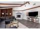 Spacious living room with vaulted ceilings, wooden beams, fireplace, and built-in shelving at 4349 W Morten Ave, Glendale, AZ 85301