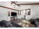 Comfortable living room featuring a large TV, stylish decor, and modern flooring at 4349 W Morten Ave, Glendale, AZ 85301