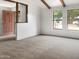 Bright living room with large windows and neutral carpet, perfect for entertaining at 4349 W Morten Ave, Glendale, AZ 85301