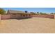 Backyard featuring desert landscaping, a storage shed, and a covered patio attached to the home at 4542 N 86Th Dr, Phoenix, AZ 85037