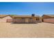 The backyard with desert landscaping includes a covered patio and access to the home through sliding glass doors at 4542 N 86Th Dr, Phoenix, AZ 85037