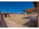 Spacious backyard featuring a covered patio area, storage shed, and desert landscaping with gravel at 4542 N 86Th Dr, Phoenix, AZ 85037