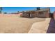 Backyard features desert landscaping, a covered patio and access to the home via a sliding glass door at 4542 N 86Th Dr, Phoenix, AZ 85037
