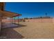 The desert landscaped backyard includes a covered patio, privacy fence and a storage shed at 4542 N 86Th Dr, Phoenix, AZ 85037