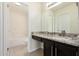 Well-lit bathroom featuring a granite countertop vanity and shower over tub combo at 4542 N 86Th Dr, Phoenix, AZ 85037