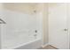 Clean bathroom featuring a tiled shower-over-tub and a doorway to the side at 4542 N 86Th Dr, Phoenix, AZ 85037