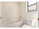 Bright bathroom showcasing a white tiled shower-over-tub and toilet at 4542 N 86Th Dr, Phoenix, AZ 85037