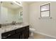 Updated bathroom featuring a window and stylish granite countertop vanity at 4542 N 86Th Dr, Phoenix, AZ 85037