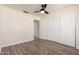 Lovely bedroom with hardwood floors, a ceiling fan, and large closet at 4542 N 86Th Dr, Phoenix, AZ 85037