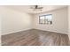 Spacious bedroom featuring hardwood floors, neutral paint, and a sunlit window at 4542 N 86Th Dr, Phoenix, AZ 85037