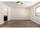 Spacious bedroom featuring hardwood floors, neutral paint, and a connecting bathroom at 4542 N 86Th Dr, Phoenix, AZ 85037