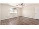 Bedroom features hardwood floors, neutral paint, and a bright window at 4542 N 86Th Dr, Phoenix, AZ 85037