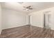Spacious bedroom featuring hardwood floors, neutral paint, and a ceiling fan at 4542 N 86Th Dr, Phoenix, AZ 85037