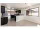 Open concept kitchen and dining area bathed in natural light with sleek cabinetry at 4542 N 86Th Dr, Phoenix, AZ 85037