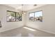 Light-filled dining area featuring neutral paint and tile floors plus large windows with neighborhood views at 4542 N 86Th Dr, Phoenix, AZ 85037