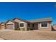 Single-story tan home with two car garage and gravel yard at 4542 N 86Th Dr, Phoenix, AZ 85037