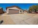 Single-story tan home with two car garage and low maintenance gravel yard at 4542 N 86Th Dr, Phoenix, AZ 85037