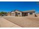 Single-story tan home with two car garage and gravel yard at 4542 N 86Th Dr, Phoenix, AZ 85037