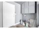 The garage features gray walls, cabinetry and a white door that leads to the interior of the home at 4542 N 86Th Dr, Phoenix, AZ 85037