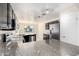 Bright kitchen featuring stainless steel appliances, granite countertops, and dark cabinetry at 4542 N 86Th Dr, Phoenix, AZ 85037