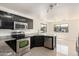 Modern kitchen with stainless steel appliances, granite counters, and sleek cabinetry at 4542 N 86Th Dr, Phoenix, AZ 85037