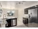 Bright kitchen featuring stainless steel appliances, granite countertops, and dark cabinetry at 4542 N 86Th Dr, Phoenix, AZ 85037