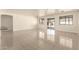 Open living room features tile floors and access to back yard via sliding glass door at 4542 N 86Th Dr, Phoenix, AZ 85037