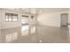 Spacious living room with tile floors, ceiling fan, and sliding glass doors to back patio at 4542 N 86Th Dr, Phoenix, AZ 85037