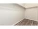 Spacious walk-in closet featuring hardwood floors and ample shelving at 4542 N 86Th Dr, Phoenix, AZ 85037