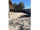 This backyard offers mature trees, a muraled block wall, and a fire pit for outdoor enjoyment at 4716 S Fair Nw Ln, Tempe, AZ 85282