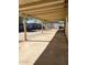 Expansive covered patio leading to a spacious backyard with murals and convenient storage shed at 4716 S Fair Nw Ln, Tempe, AZ 85282