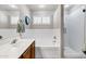 Bright bathroom features a single sink vanity, soaking tub and a glass enclosed shower, perfect for relaxation at 5046 W Monte Cristo Ave, Glendale, AZ 85306
