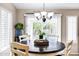 Cozy dining area with a dark wood table and natural light from the sliding doors at 5046 W Monte Cristo Ave, Glendale, AZ 85306