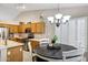 Bright kitchen with stainless appliances, an island, and an adjacent dining area at 5046 W Monte Cristo Ave, Glendale, AZ 85306