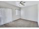 Bedroom with neutral carpet, window, and a glass sliding door at 537 S Delaware Dr # 224, Apache Junction, AZ 85120