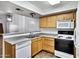 Functional kitchen with wood cabinets, white appliances, and laminate countertops at 537 S Delaware Dr # 224, Apache Junction, AZ 85120