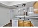 Kitchen view featuring a double sink, white appliances and wood cabinetry at 537 S Delaware Dr # 224, Apache Junction, AZ 85120