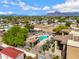 Aerial shot of community pool area with mountain views surrounded by lush landscaping and residential buildings at 537 S Delaware Dr # 224, Apache Junction, AZ 85120