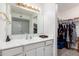 Bathroom featuring a white vanity with a marble countertop and a walk-in closet at 6207 N 21St Dr, Phoenix, AZ 85015