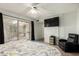 Comfortable bedroom featuring a sliding glass door, ceiling fan, and reading chair at 6207 N 21St Dr, Phoenix, AZ 85015
