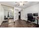 Bedroom featuring hardwood floors, ceiling fan, and mirrored closet at 6207 N 21St Dr, Phoenix, AZ 85015