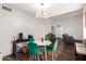Open dining area with hardwood floors, a round table with green chairs, and ample natural light at 6207 N 21St Dr, Phoenix, AZ 85015