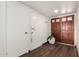 Hallway with wood floors and two doors, one being a double wooden door at 6207 N 21St Dr, Phoenix, AZ 85015