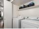 Functional laundry room with appliances and shelving providing ample space for organizing laundry essentials at 6207 N 21St Dr, Phoenix, AZ 85015