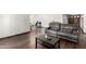 Living room with hardwood floors, large sofa, and view of dining area and front door at 6207 N 21St Dr, Phoenix, AZ 85015