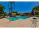 Sparkling community pool surrounded by lounge chairs and manicured landscaping, perfect for summer relaxation at 6207 N 21St Dr, Phoenix, AZ 85015