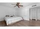 Bedroom with wood-look floors, ceiling fan and large window to provide natural light at 654 W Plata Ave, Mesa, AZ 85210