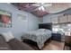 Bedroom decorated with dark furniture, ceiling art, and posters covering the walls at 654 W Plata Ave, Mesa, AZ 85210