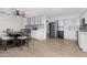 Bright and airy kitchen with modern appliances, white cabinets, and a dining area at 654 W Plata Ave, Mesa, AZ 85210