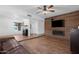 Spacious living room with a wooden accent wall featuring a fireplace and ceiling fan at 654 W Plata Ave, Mesa, AZ 85210